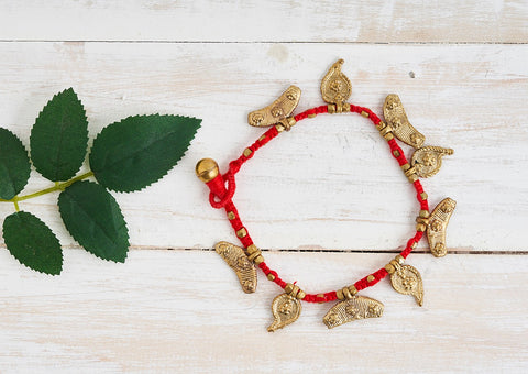 Paisley Dhokra anklet with golden metal alloy and red cotton thread