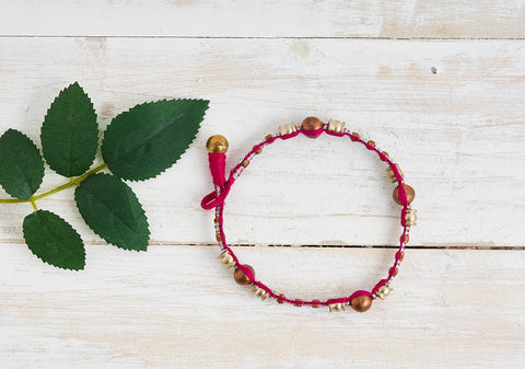 Ethno Dhokra anklet with Dhokra beads and deep pink cotton thread