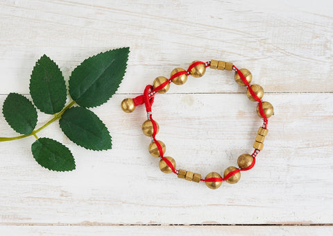 Dhokra anklet with brass beads and balls and red cotton thread